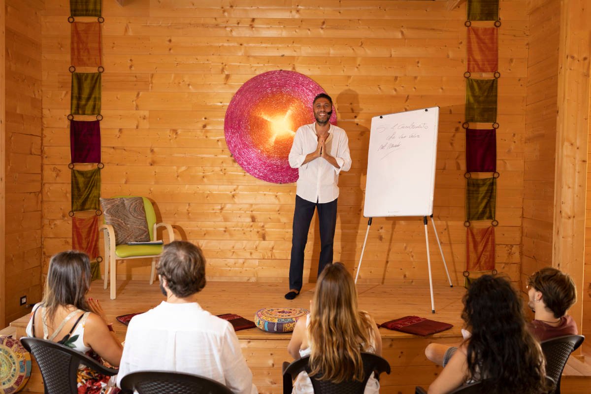 Riccardo leading a group session in a wooden studio